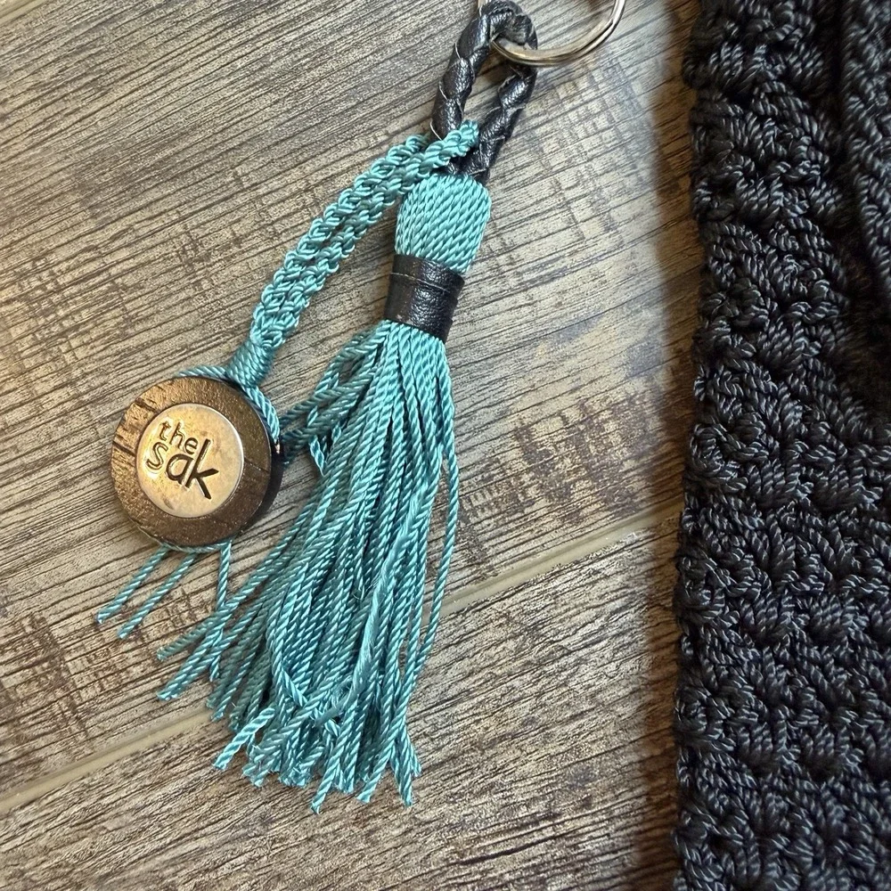 The Sak Black Crochet Crossbody Bag Mini Flap Purse Boho with Teal Tassel Charm